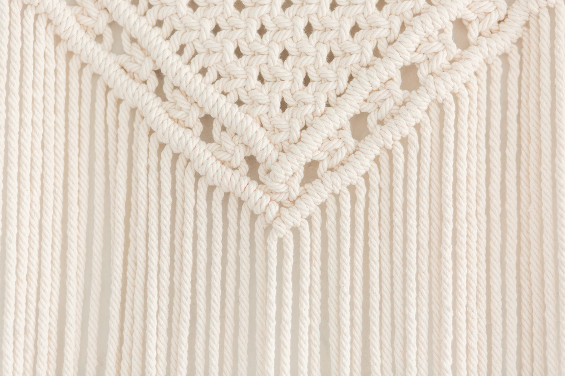 Close up of handmade macrame panel. Texture. Background.