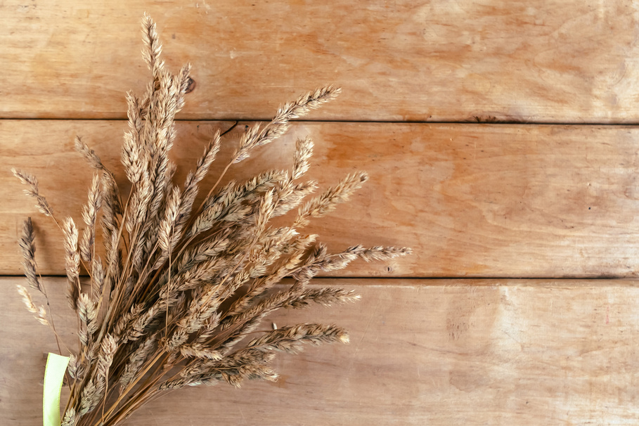 Bouquet of dried flowers on wooden background, top view.